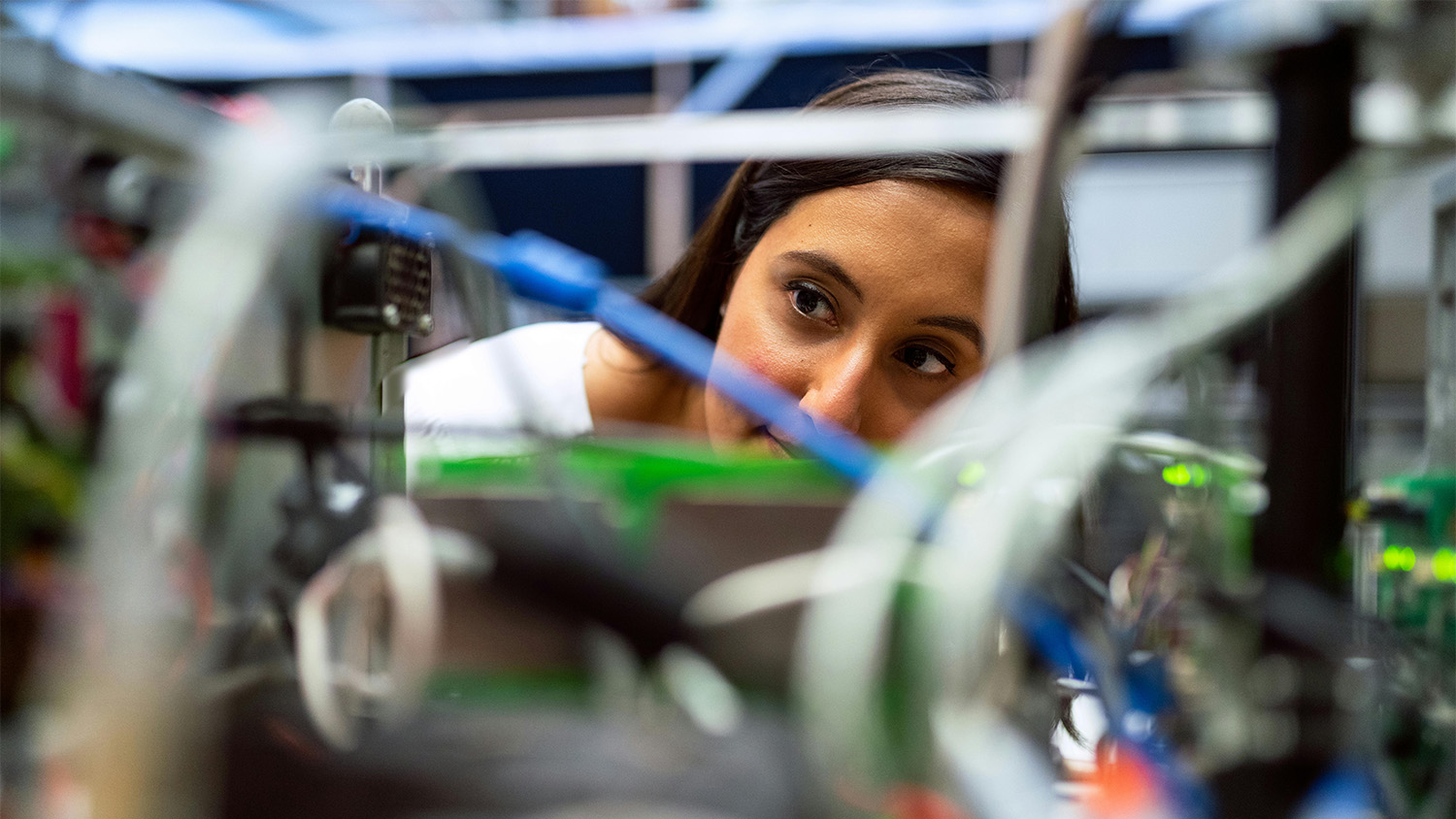 Close up of an engineer looking through machinery 